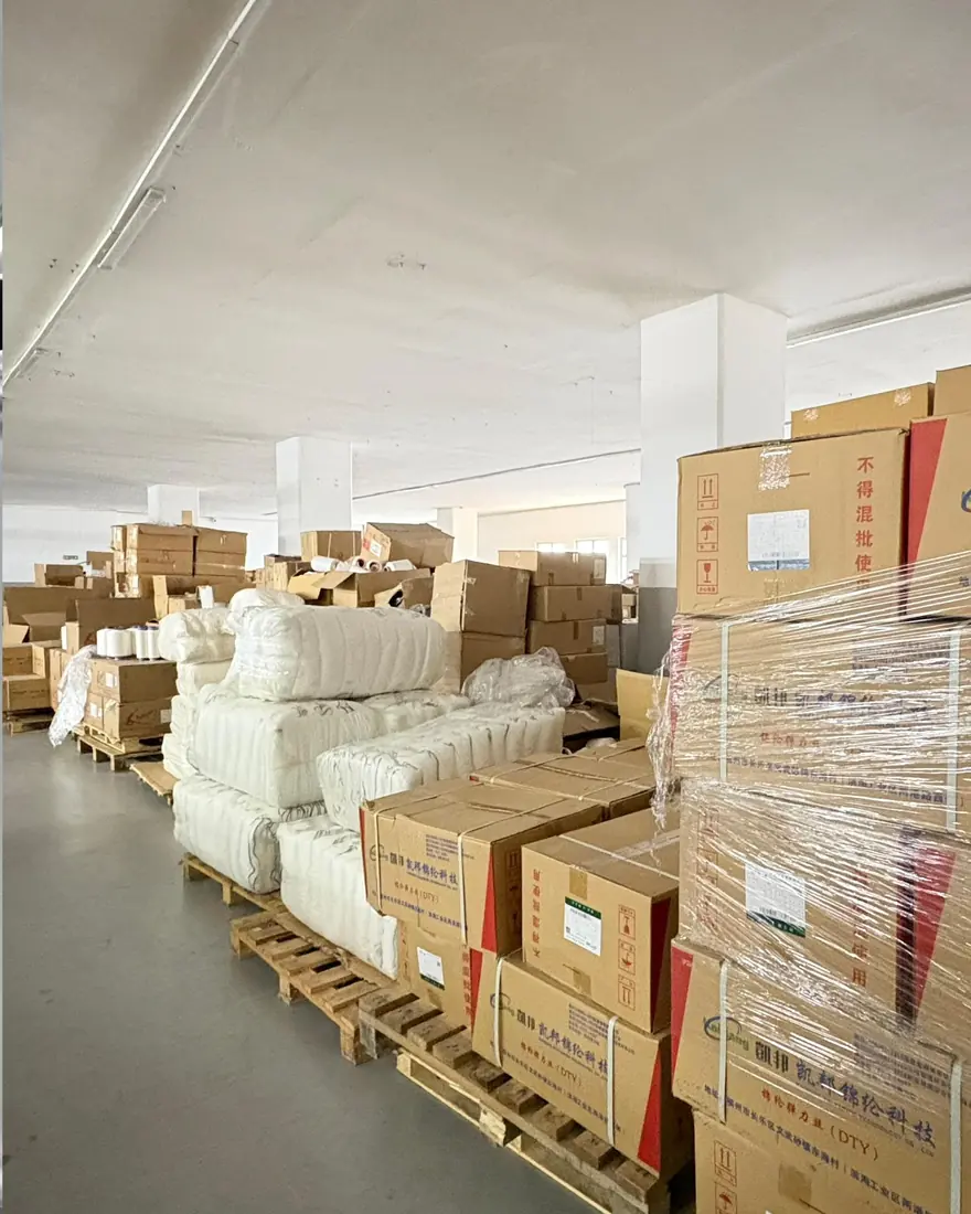 Yarn and greige seamless fabric stocked on pallets inside the Istanbul facility
